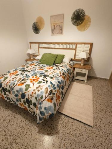 a bedroom with a bed with a colorful comforter at La Panaderia 8 PAX, terraza exterior in Cenicero