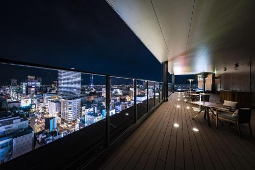 a balcony with a view of the city at night at SAPPORO STREAM HOTEL in Sapporo