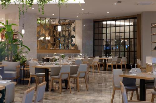 a restaurant with tables and chairs in a room at Miramare Beach Hotel - Ultra All Inclusive in Side