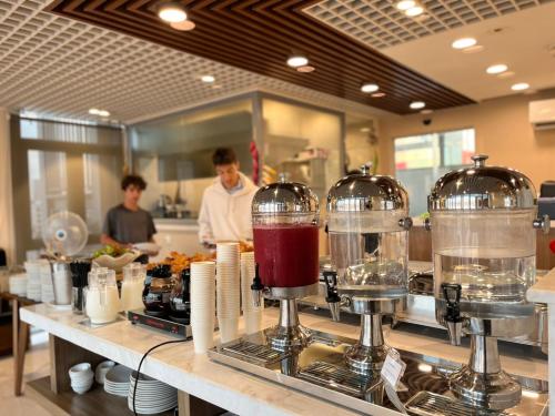a kitchen with two blenders on a counter at Aurora Western Village in Ho Chi Minh City