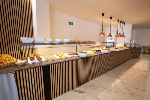 a buffet line with many different types of food at FLEMING PLAYA PONIENTE in Benidorm
