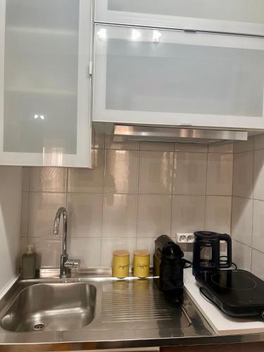 a kitchen counter with a sink and a microwave at Central Park in Corfu