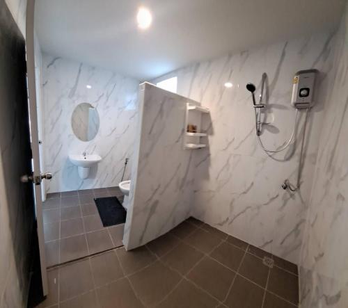 a white bathroom with a sink and a toilet at K.K. Park Resort in Khao Sok