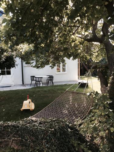 a backyard with a swing set in the grass at Mullbärsgårdens Bed and Breakfast in Visby