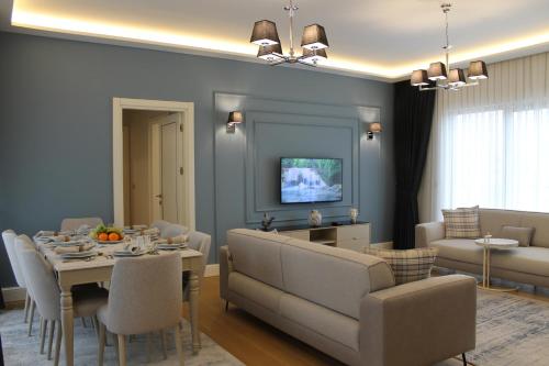 a living room with a table and a dining room at Garlon Residence in Istanbul