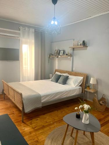a bedroom with a large bed and a table at Central Park in Corfu