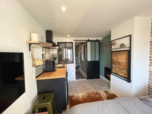 a small kitchen with a counter in a room at Love and spa vue montagne in La Penne