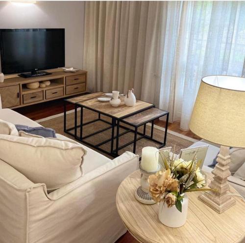 a living room with a white couch and a television at LAR DA REVOLTA in Cedeira