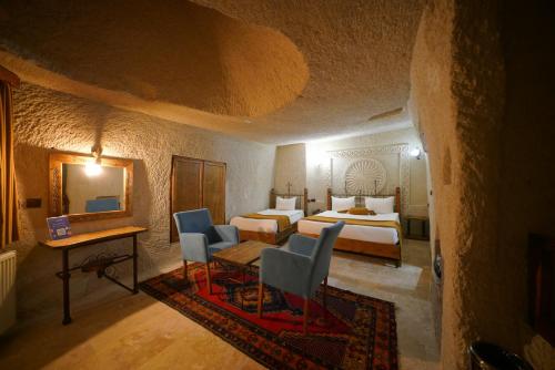 a hotel room with a bed and a table and chairs at Elite Cave Suites in Goreme