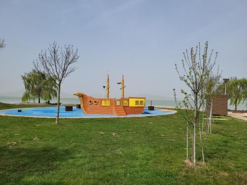 a playground with a boat in a park at Lido Dalma Apartman 2 in Fonyód
