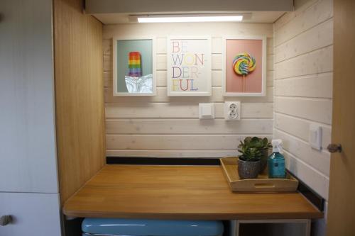 a small room with a wooden table and a blue stool at Camping Oleiros in Oleiros