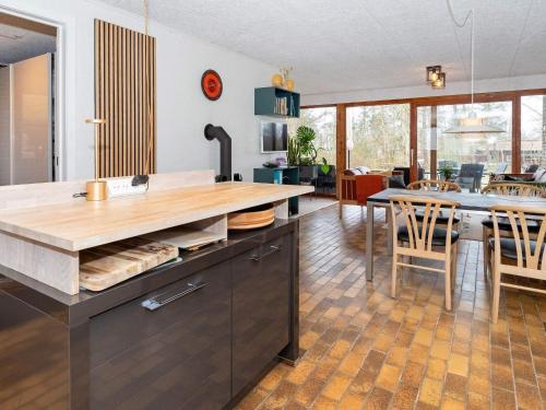 a kitchen with a counter and a dining room at 5 person holiday home in Thyholm-By Traum in Thyholm