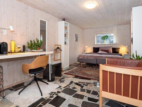 a bedroom with a bed and a desk and a chair at 5 person holiday home in Thyholm-By Traum in Thyholm