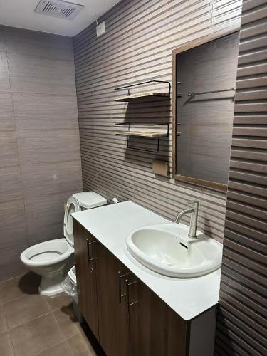 a bathroom with a sink and a toilet at One Spatial Condominium, 2-Bedroom Unit #2920 in Iloilo City