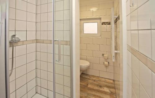 a bathroom with a toilet and a glass shower at Fh Blau in Warenthin