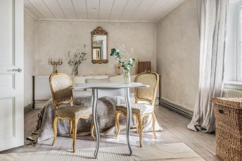 a dining room with a table and chairs at Large Stylish Charming House With Big Garden in Eskilstuna
