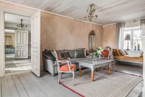 a living room with a couch and a table at Large Stylish Charming House With Big Garden in Eskilstuna