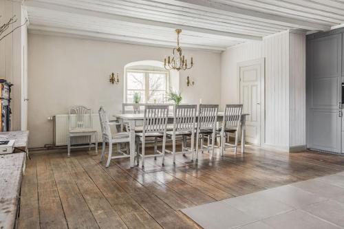 a dining room with a table and chairs at Large Stylish Charming House With Big Garden in Eskilstuna
