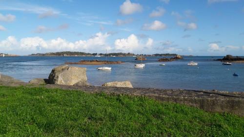a large body of water with boats in it at Charmante maison de pecheur in Ploubazlanec