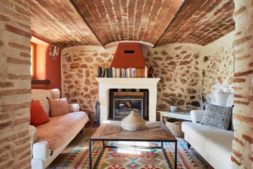 a living room with a couch and a fireplace at Château de Berne in Lorgues