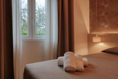 a bedroom with a bed with towels on it at Hotel Palazzo del Garda & Spa in Desenzano del Garda