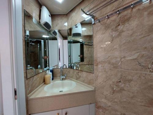 a bathroom with a sink and a large mirror at Leonardo hotel , Very luxury suite, high floor, in fron of See in Bat Yam