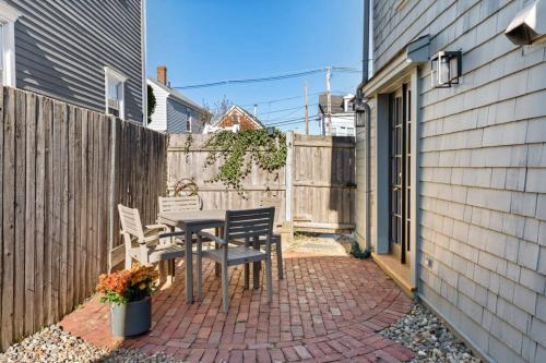 a patio with a table and chairs and a fence at Circa 1789 Historic South End Downtown Home in Newburyport