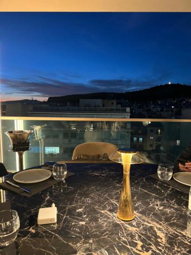 a table with wine glasses on top of a building at Heritage Hill Hotel in Athens