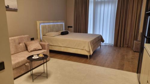 a living room with a bed and a couch at Sea Breeze Lighthouse 3 in Baku