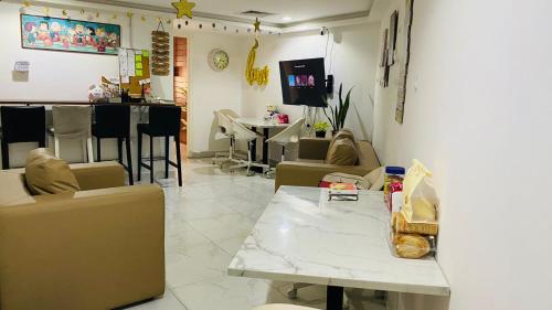 a living room with couches and a table and a bar at Yoi Pod Hostel - Deira Al Rigga in Dubai