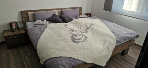 a bed with a blanket with a deer on it at Haus Ludwig in Freudenstadt
