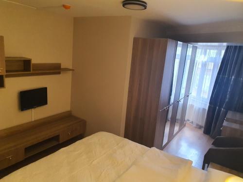 a bedroom with a bed and a tv and a window at KADIKÖY BRISTOL HOTEL in Istanbul