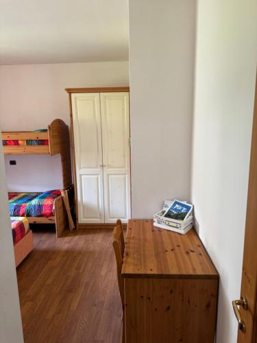 a room with a table and a bedroom with a bunk bed at Hotel Culmine in Ardenno