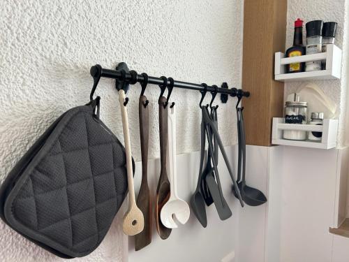 a rack of cooking utensils hanging on a wall at SCHWARZWALDNACHT mit Sauna im Haus ideal zum wandern und biken Balkon Tiefgarage E-Ladestation in Todtnauberg