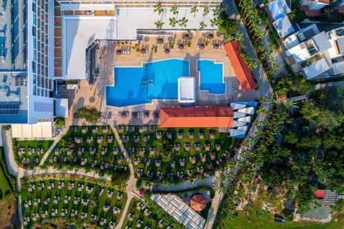 an overhead view of a building with a swimming pool at Cavo Maris Beach Hotel in Protaras