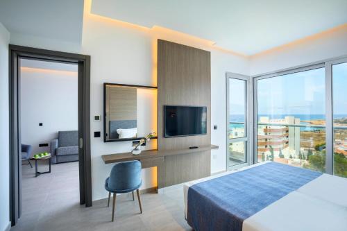 a hotel room with a bed and a television at Cavo Maris Beach Hotel in Protaras