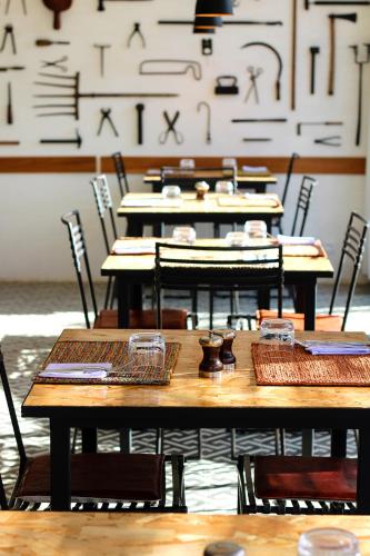 a group of tables and chairs in a room at Nosy Manga - Hotel Ivato Airport in Antananarivo
