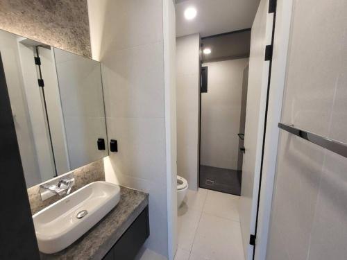 a white bathroom with a sink and a toilet at Stay Beff in Gwangju