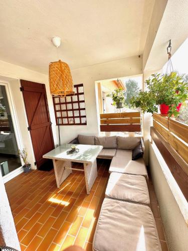 a room with a couch and a table on a balcony at Appartement Spacieux proche des Plages de la coudouliere in Six-Fours-les-Plages