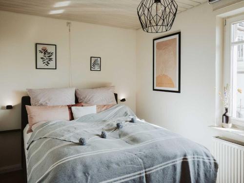 a bedroom with a bed with a blue blanket on it at Ferienwohnung Bodenseeblick in Allensbach