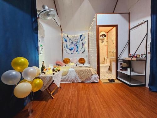 1 dormitorio con cama y mesa con globos en Homstay Mimosa Mộc Châu en Mộc Châu