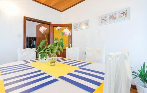 a dining room table with a blue and white striped table cloth at Rooms Croatia with parking, kitchen and dining area for guests in Rijeka