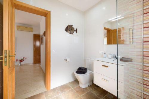 a bathroom with a shower and a toilet and a sink at Villa Primera in Playa Blanca