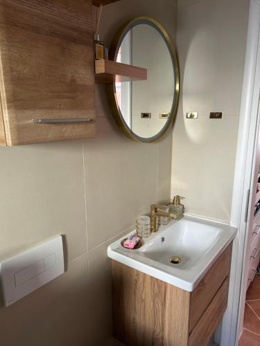 a bathroom with a sink and a mirror at Holiday house Matej in Vir