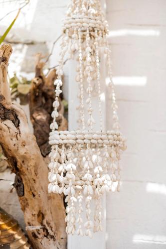 a bunch of pearl beads hanging on a wall at Conchiglia Village House in Kiotari
