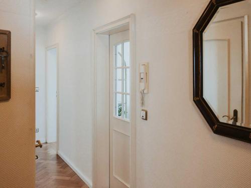 a hallway with a mirror next to a door at Ferienwohnung Bodenseeblick in Allensbach
