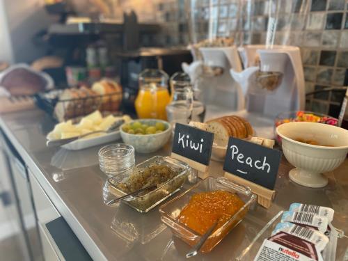 a buffet with bread and other food on a counter at Casa do Mundo Madeira in Gaula