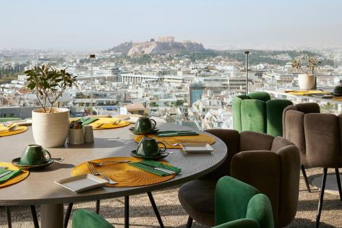 a table and chairs with a view of a city at St George Lycabettus Lifestyle Hotel in Athens
