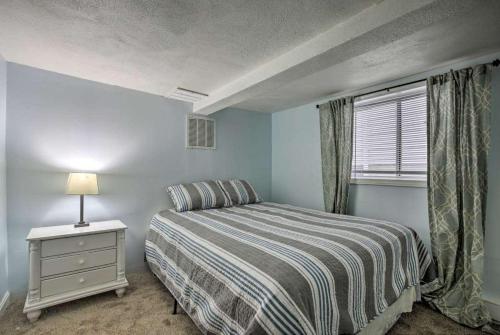 a bedroom with a bed with a nightstand and a window at Ground Floor Unit - The Americana in Hampton