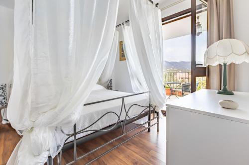 a bedroom with a bed and a table with a lamp at Stunning Villa Paola with Swimming Pool & Terrace! in Villasimius